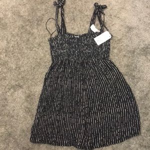 Lightweight romper, stretchy on top, tied straps